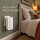Aerensa One plugged into a bedroom wall beside a bed, with sage green decor and warm lighting. Your room. Your routine.