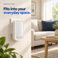 Aerensa One plugged into a wall outlet beside a warm living room. Fits into your everyday space.